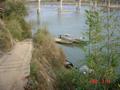 #3: The boat serving as the only means of river crossing until the bridge in the background is completed