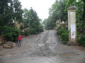 #4: Turnoff to the confluence 1.64 km NE, with Ah Feng pointing out the sole remaining concrete pillar.