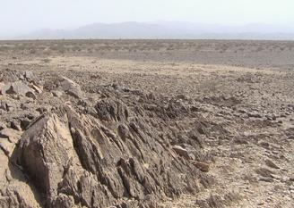 #1: Looking down on the plain that contains the confluence point from the nearest hill (northeast of 16N 39E)