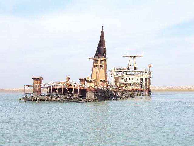 Looking north past the point, the southwest edge of al-Fāw peninsula in the background