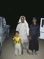 #12: Nasr, his infant son, and Ma'tib (modelling his England Cricket Team cap)